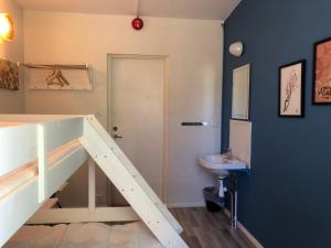 a bathroom with a staircase with a sink and a toilet at Vandrarhem, Hostel in Hällestrand Semesterby in Strömstad