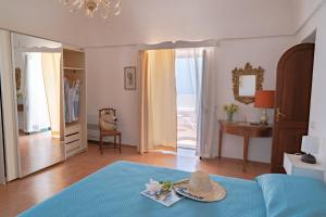a bedroom with a blue bed with a hat on it at Casa Lalù - Rustic apartment with stunning views in Positano