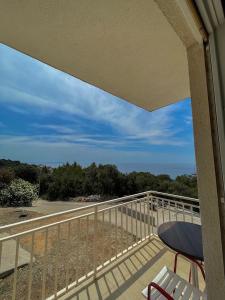 a balcony overlooking a beach with a view of the ocean at Apartments Marija Magdalena in Hvar