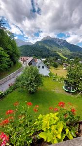 a view of a yard with flowers and a house at Apartments Ela in Rateče