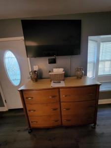 a dresser with a flat screen tv on top of it at Near Beale Street, 6BR - 3BA 16 BEDS Sleeps up to 37 Guest in Memphis
