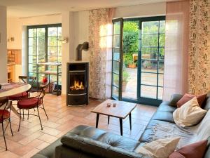 a living room with a couch and a fireplace at Ferienhaus Prerow in Prerow