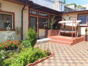 a house with a porch with a swing at Casa Kogalniceanu in Constanţa