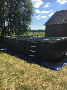 a swimming pool with a ladder in a yard at Dom na Podlasiu in Klepacze