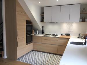 a kitchen with white cabinets and a sink at Agréable maison neuve Angers Centre-Madeleine in Angers