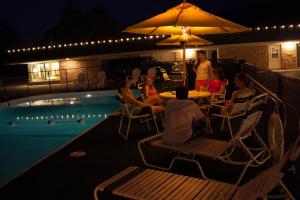 a group of people sitting at a table next to a pool at Fort Davidson Hotel in Pilot Knob