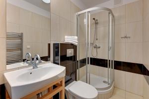 a bathroom with a sink and a shower and a toilet at Apartamenty PIAMOLA Willa Turkusowa in Kąty Rybackie +86 photos