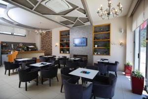 a restaurant dining room with tables and chairs at Hotel Summer Stars in Vlorë