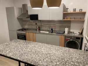 a kitchen with a counter top and a stove top oven at BLU Apartments in Bamako