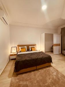 a bedroom with a large bed in a room at BLU Apartments in Bamako