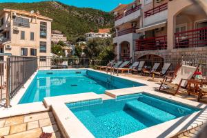 a swimming pool on top of a building at Villa Savovic in Petrovac na Moru