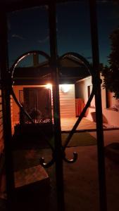 a view of a house from a window at night at SECRET33 in Floirac