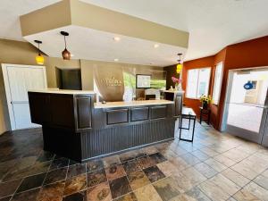 a restaurant with a bar in the middle of a room at Court Plaza Inn & Suites of Mackinaw in Mackinaw City