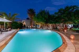 a swimming pool in a resort at night at Inspira Boutique Hotel Thassos - Adults Only in Prinos
