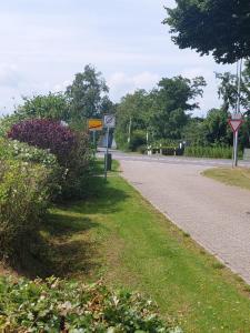 una carretera con señales a un lado de la carretera en Meeresleuchten, en Krummhörn