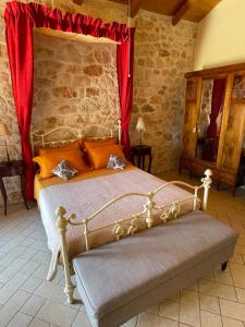 a bedroom with a bed with a red curtain at Boutique apart-hotel Galini, member of the best small hotels in Greece, Adults only in Volímai +26 photos
