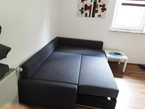 a black couch in a room with a window at Apartment-Ferienwohnung 3 Treffen am Ossiachersee in Treffen