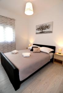 a bedroom with a large bed with two towels on it at MiKa in Kaštela
