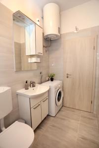 a bathroom with a sink and a washing machine at MiKa in Kaštela +20 photos