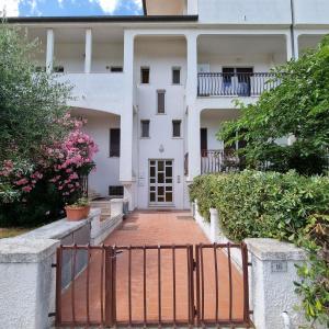 an external view of a building with a gate at Appartamento Corallo in Porto Recanati