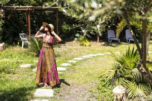 a woman in a dress talking on a cell phone at Bristol Hotel in Ischia