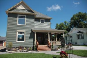 a blue house with a porch and a house at Inn136 Guest House in Kingsville