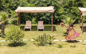 a figurine of a woman standing in a yard with chairs at Bristol Hotel in Ischia