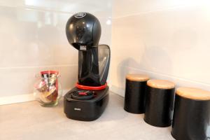 a black blender sitting on a counter with twoools at MiKa in Kaštela
