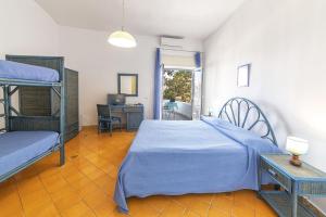 a bedroom with two bunk beds and a desk at Bristol Hotel in Ischia