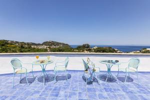 a couple of tables and chairs on a patio at Bristol Hotel in Ischia