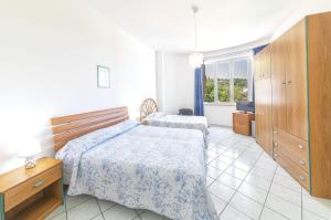 a bedroom with two beds and a window at Bristol Hotel in Ischia