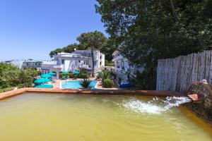 a large pool of water in front of a house at Bristol Hotel in Ischia