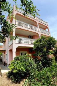 a pink building with balconies on the side of it at MiKa in Kaštela