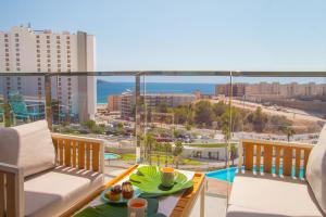 a balcony with a table and a view of the ocean at Waves apartment - relax in Costa Blanca in Benidorm