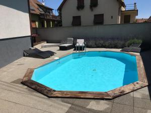 a swimming pool in the backyard of a house at LE STUDIO SELESTADIEN in Sélestat