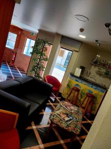 ein Wohnzimmer mit einem Sofa und 2 Stühlen in der Unterkunft Hotel Nova Cidade in Amadora