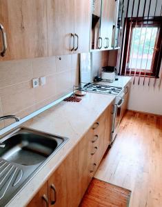 a kitchen with a sink and a stove at Lake House in Jurilovca