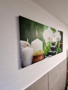 a picture of candles and flowers on a wall at Altstadt-FeWo-Freiberg in Freiberg