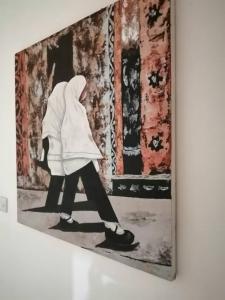 a painting of a person walking in a room at More Than A Drop in Moshi