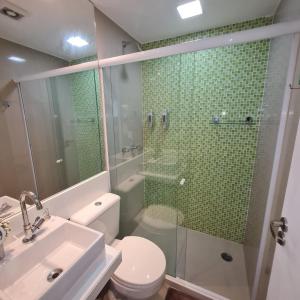 a bathroom with a shower and a toilet and a sink at Flat Luxo no Villa Hípica em Gravata - PE - LocarHouse in Gravatá