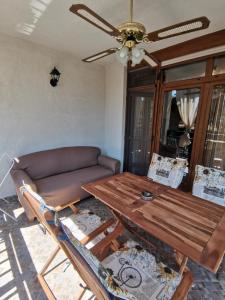 a living room with a table and a couch at Quiet apartment with big terrace in Santa Marina with parking in Sozopol