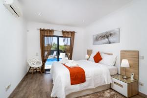 a bedroom with a bed and a window at CASA CHLOE in Moncarapacho +13 photos