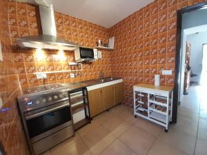 a kitchen with a stove and a counter top at Can Beia Rural House Ibiza in Nuestra Señora de Jesus