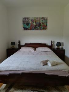 a bedroom with a large bed with two towels on it at Vila Coka in Nova Varoš