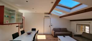 a living room with a couch and a skylight at Loft 80m2 en plein cœur de la vieille ville 3 étoiles in Toulon