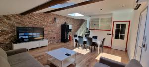 a living room with a couch and a table with chairs at Loft 80m2 en plein cœur de la vieille ville 3 étoiles in Toulon