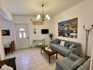 a living room with a couch and a table at Gallery Apartments in Lixouri