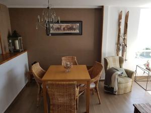 a dining room with a table and chairs at Las mejores vistas del valle. Apartmento 65m.WIFI in Cerler