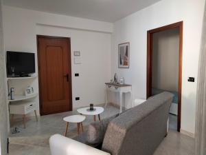 a living room with a couch and a table at Finestra sul Mare di Alessandro in Balestrate