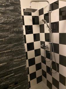 a bathroom with a black and white checkered shower at Maison Lolly corse wifii free in Borgo +10 photos